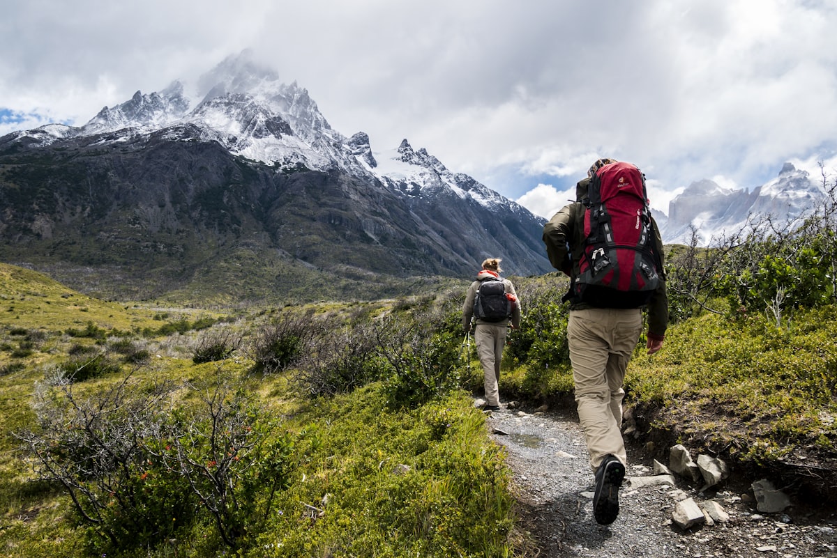 Backpacker adjusting layers on a mountain pass